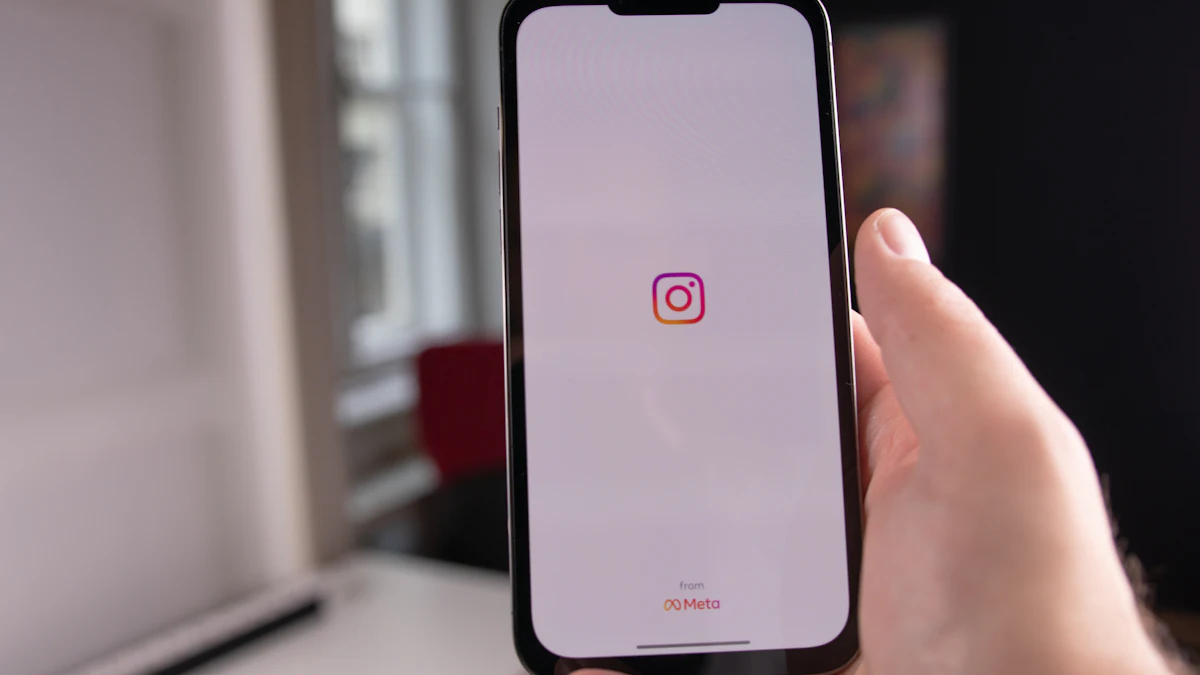 Hand holding a phone with the Instagram app opening